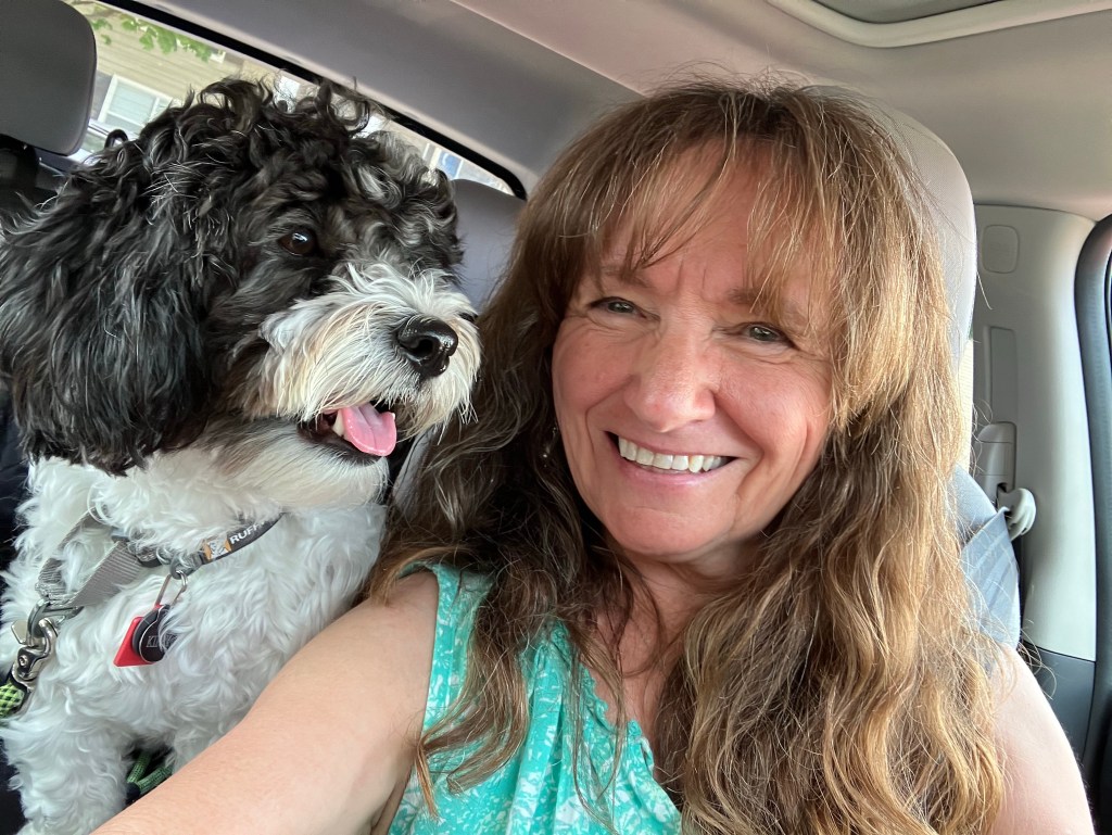 Pati Rader and dog Kippy, riding in the car